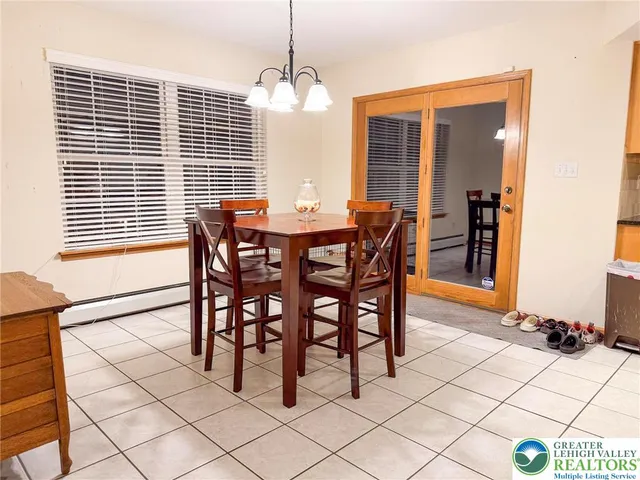 a view of a dining room with furniture and window