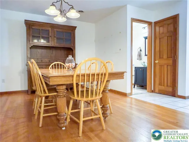 a view of a dining room with furniture wooden floor and chandelier