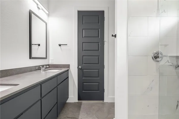 a bathroom with a granite countertop sink and mirror