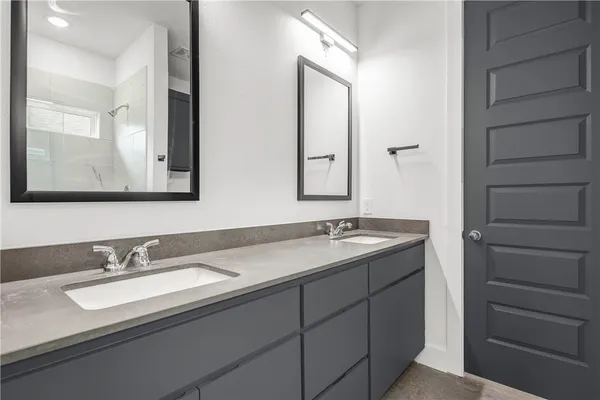a bathroom with a double vanity sink and mirror