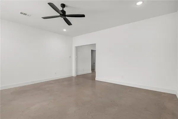 a view of empty room with ceiling fan