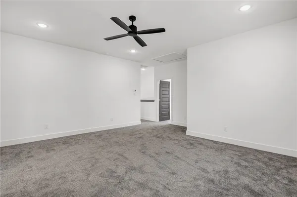 an empty room with closet and windows