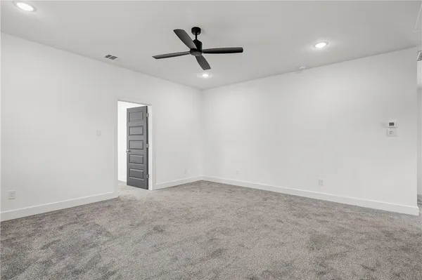 an empty room with closet and windows