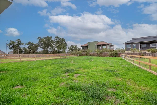 a view of yard with swimming pool and green space