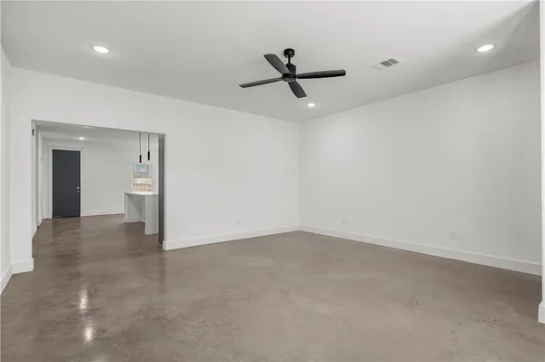 an empty room with a empty space and windows