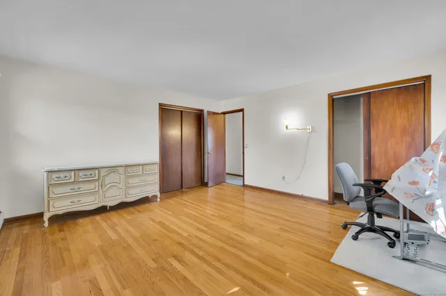 a view of an empty room and wooden floor