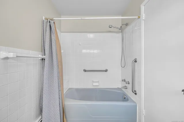 a bathroom with a tub and shower