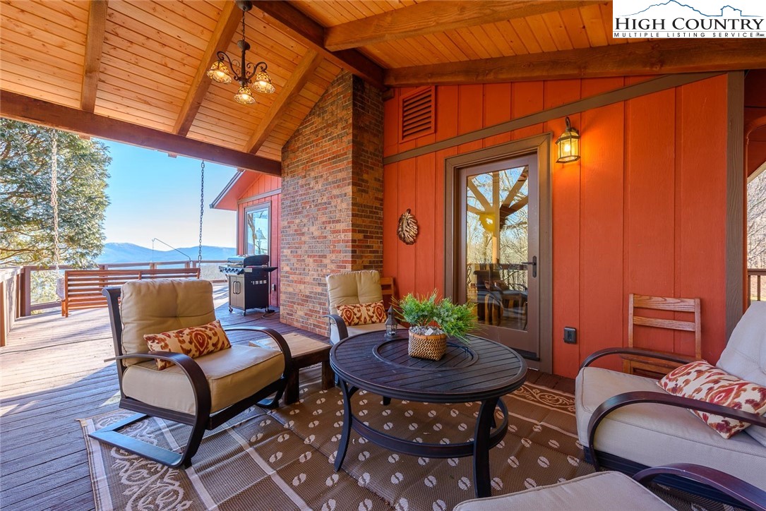 1776 Beech Mountain Parkway Beech Mountain, NC 28604 - Photo 1 of 34 a outdoor living space with furniture and a fireplace