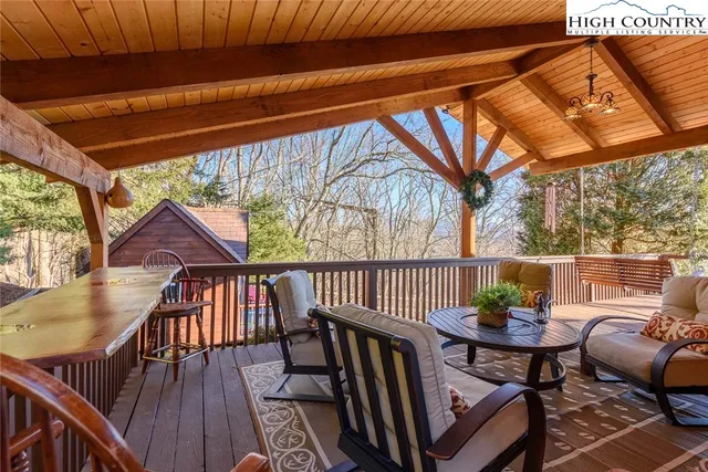 a view of balcony with furniture and wooden deck