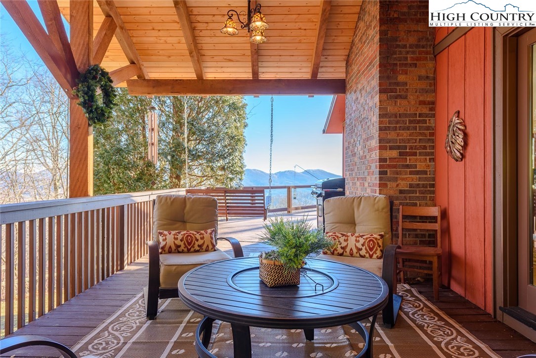 1776 Beech Mountain Parkway Beech Mountain, NC 28604 - Photo 16 of 34 a view of a balcony with table and chairs
