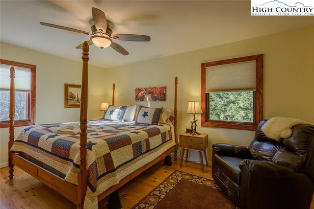 a bedroom with a bed couch and window