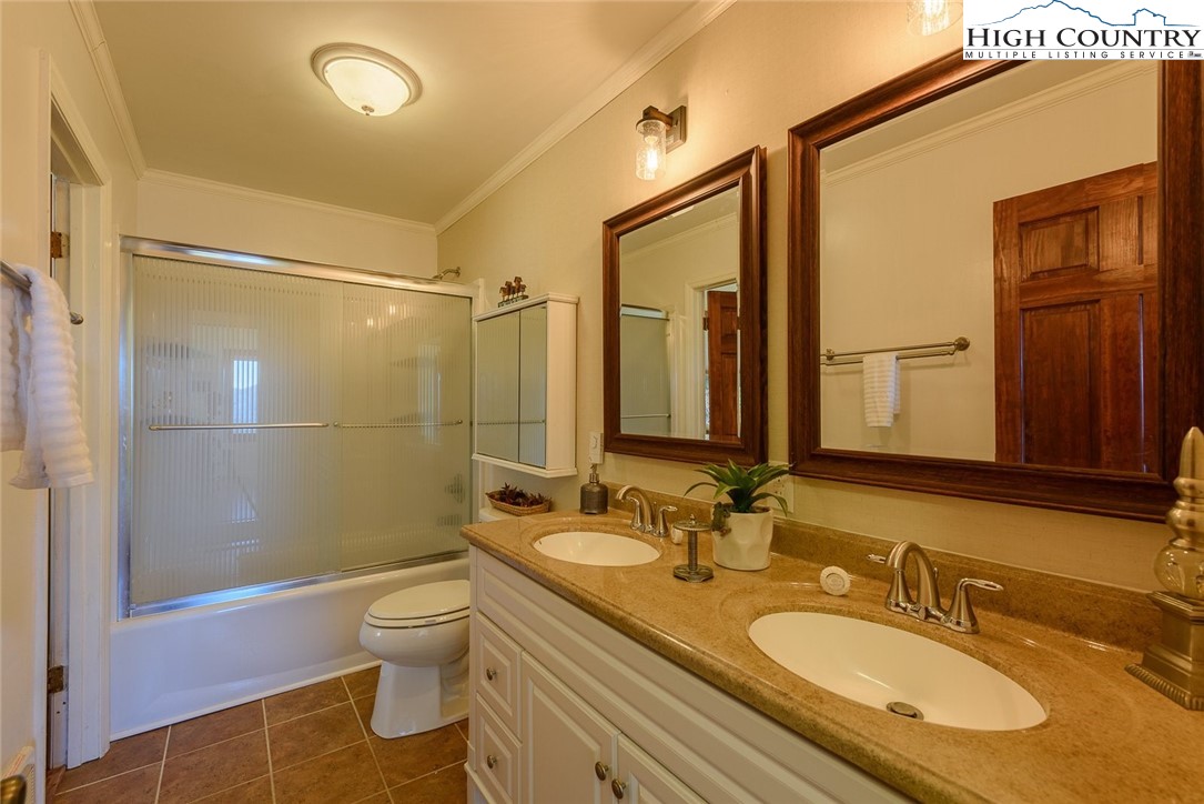 1776 Beech Mountain Parkway Beech Mountain, NC 28604 - Photo 19 of 34 a bathroom with a granite countertop sink toilet and shower