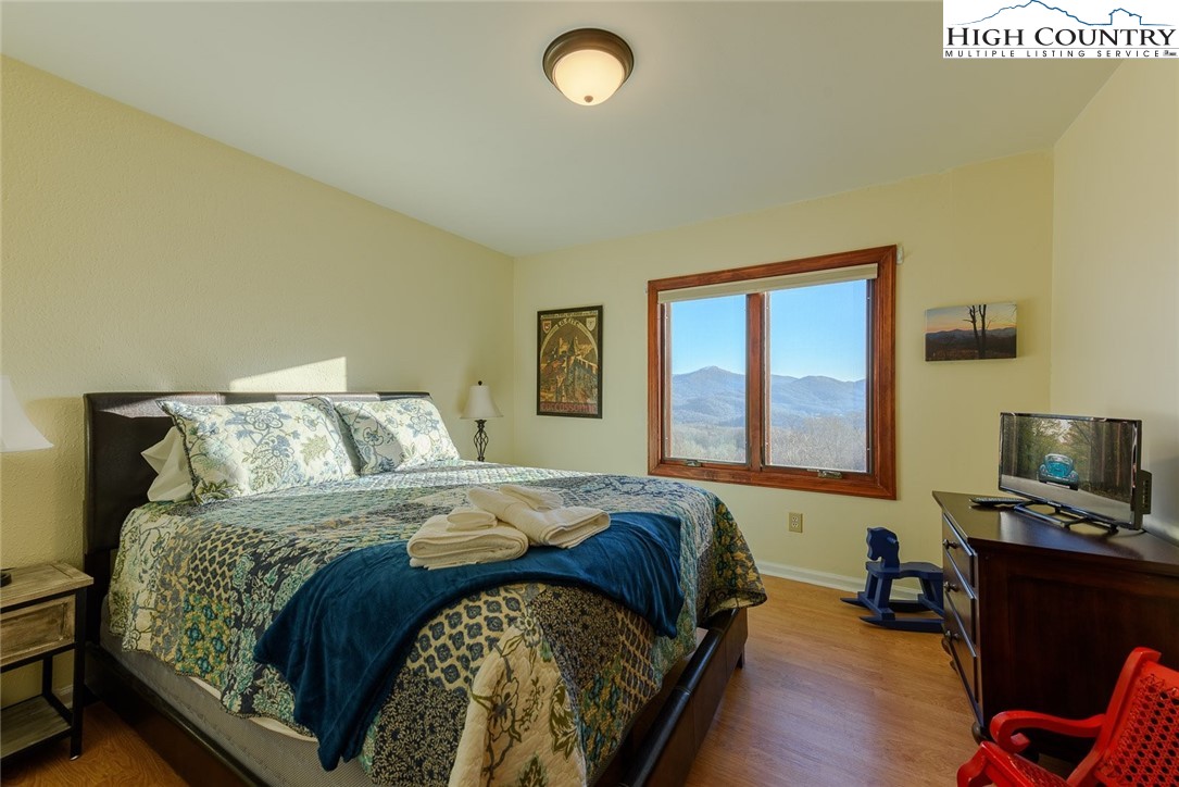 1776 Beech Mountain Parkway Beech Mountain, NC 28604 - Photo 20 of 34 a bedroom with a bed and a window