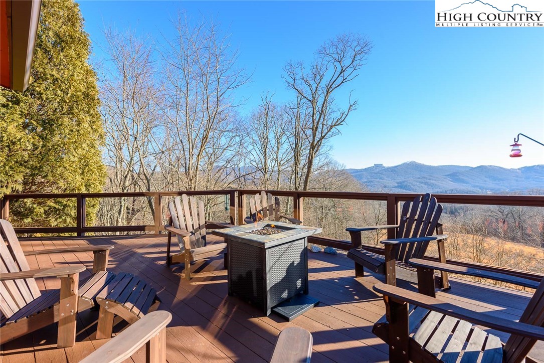 1776 Beech Mountain Parkway Beech Mountain, NC 28604 - Photo 2 of 34 a balcony with wooden floor table and chairs