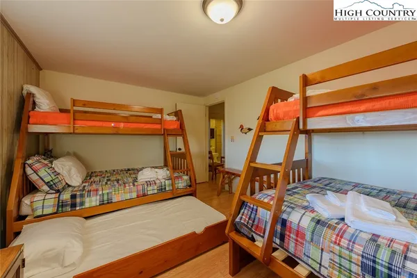 a bedroom with a bed and wooden floor