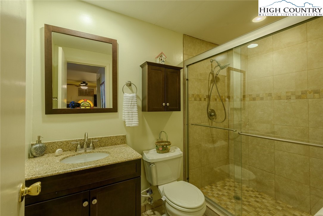 1776 Beech Mountain Parkway Beech Mountain, NC 28604 - Photo 27 of 34 a bathroom with a granite countertop sink toilet and shower