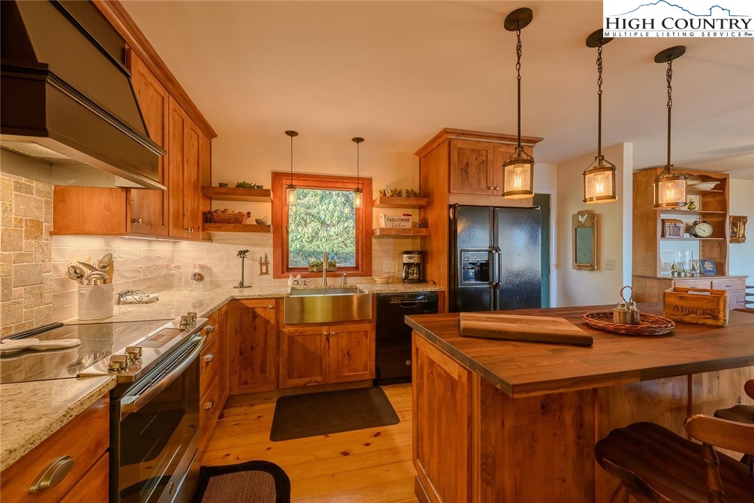 1776 Beech Mountain Parkway Beech Mountain, NC 28604 - Photo 7 of 34 a kitchen that has a lot of cabinets in it