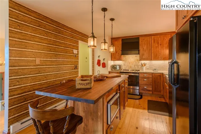 a kitchen with stainless steel appliances a stove a sink refrigerator and a microwave