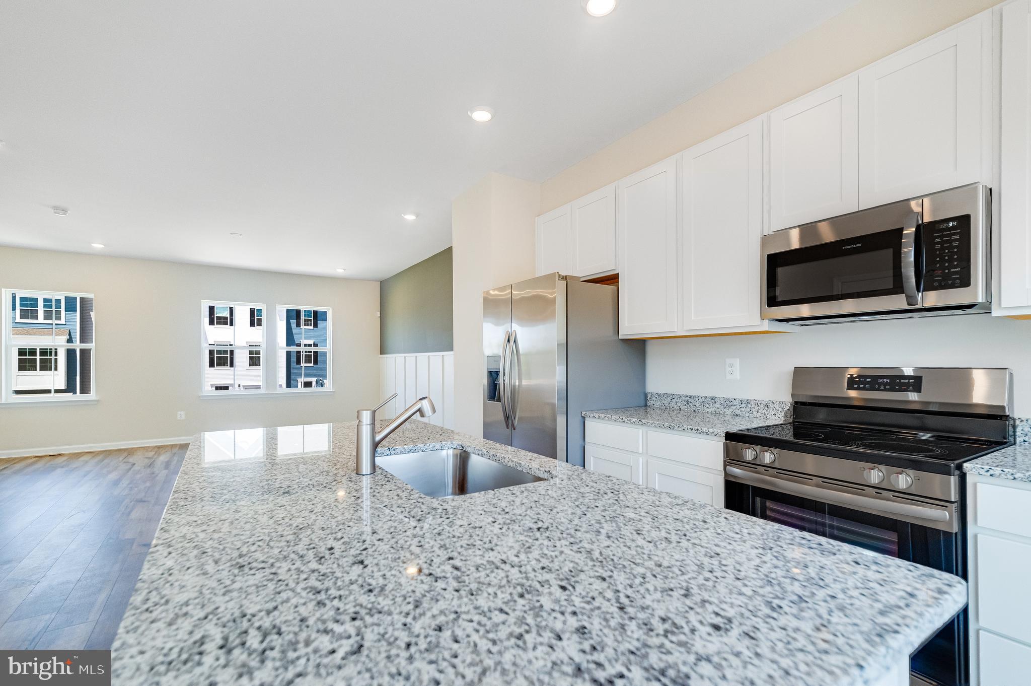 410 18th Avenue Ranson, WV 25438 - Photo 3 of 26 a kitchen with stainless steel appliances granite countertop a stove a sink and a microwave