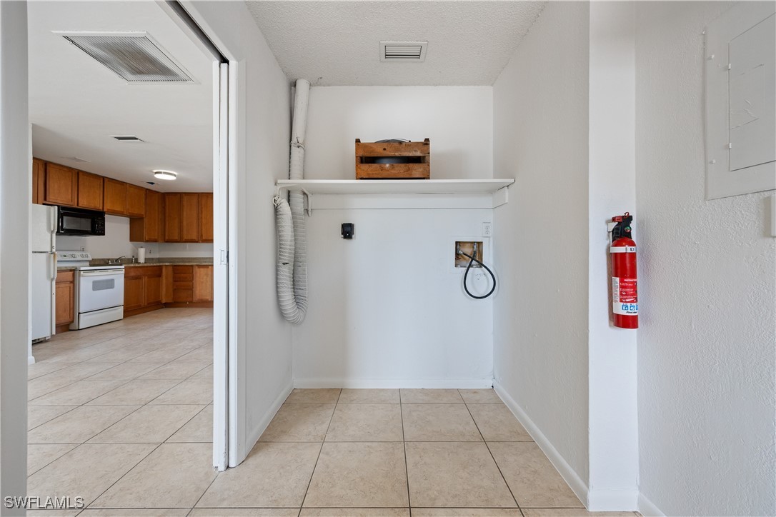 12955 First Street Fort Myers, FL 33905 - Photo 19 of 48 a view of kitchen with stainless steel appliances granite countertop a refrigerator and a stove top oven