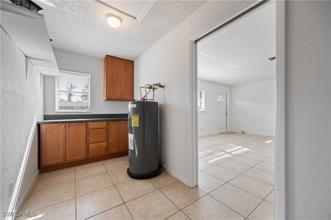 12955 First Street Fort Myers, FL 33905 - Photo 20 of 48 a view of a refrigerator in kitchen and an empty room