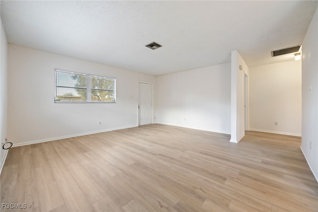 12955 First Street Fort Myers, FL 33905 - Photo 25 of 48 an empty room with wooden floor and windows