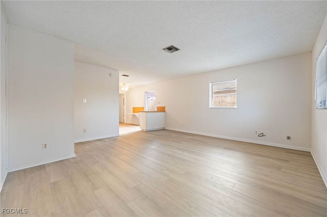 12955 First Street Fort Myers, FL 33905 - Photo 28 of 48 a view of empty room with wooden floor and windows