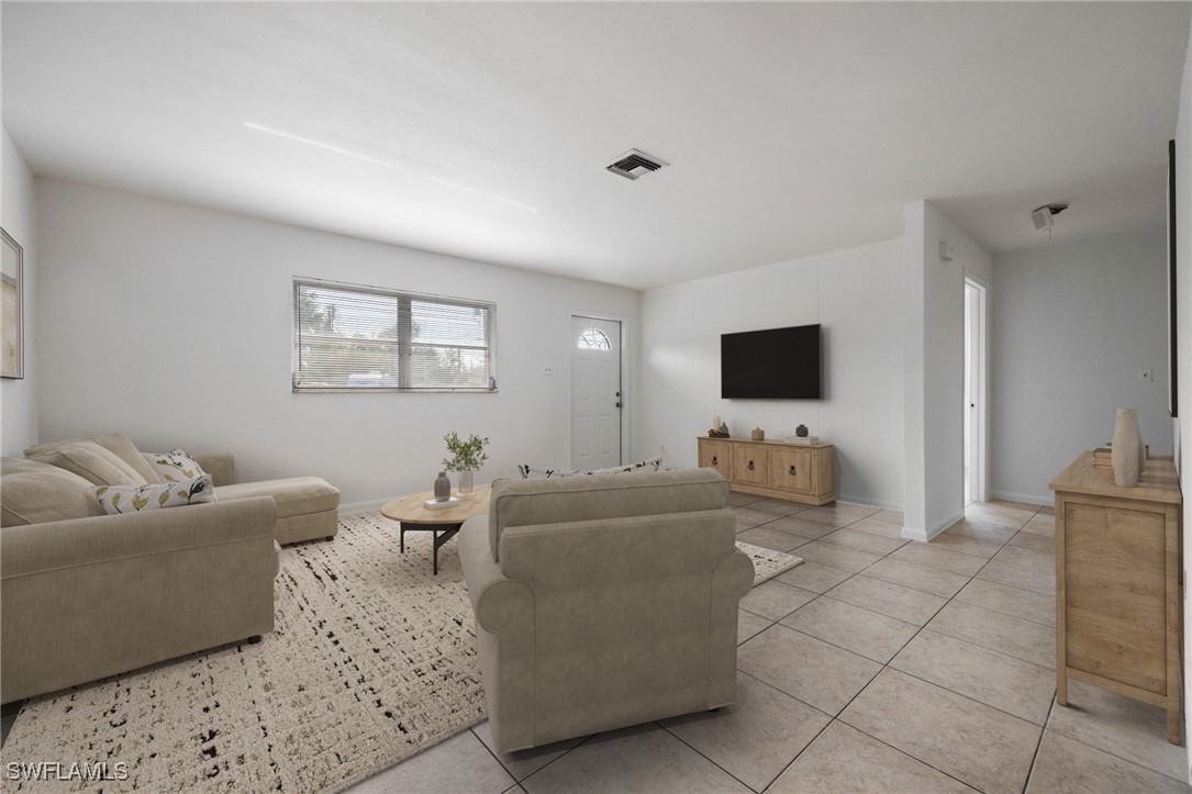 12955 First Street Fort Myers, FL 33905 - Photo 7 of 48 a living room with furniture and a flat screen tv