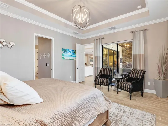 a bedroom with a bed chair and a large window