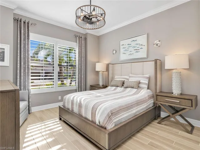 a bedroom with a bed and a large window