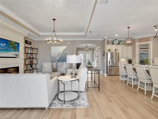 a living room with furniture a dining table and a fireplace