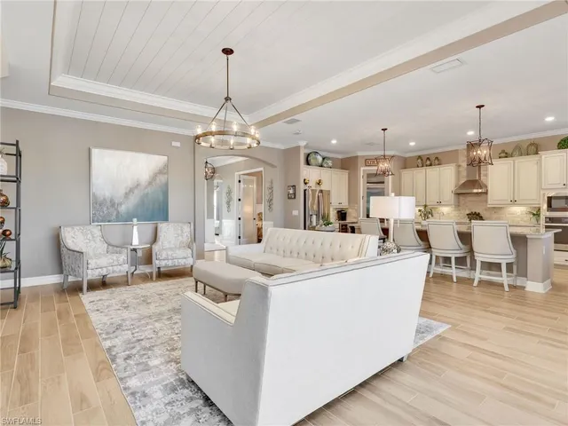a living room with lots of furniture and a chandelier
