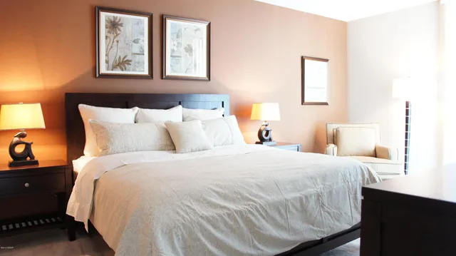 a bedroom with a bed and a mirror