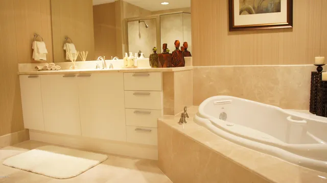 a bathroom with a tub and shower