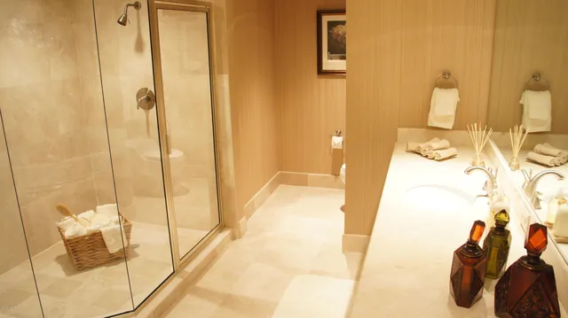 a bathroom with a shower and a sink