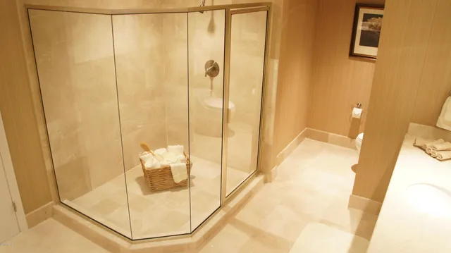 a blue swimming pool with chairs