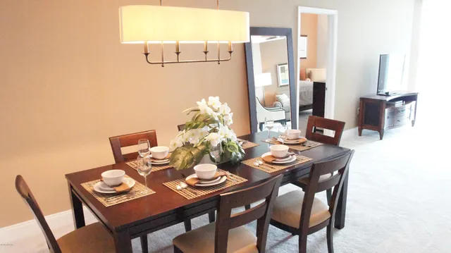 a dining room with furniture and window