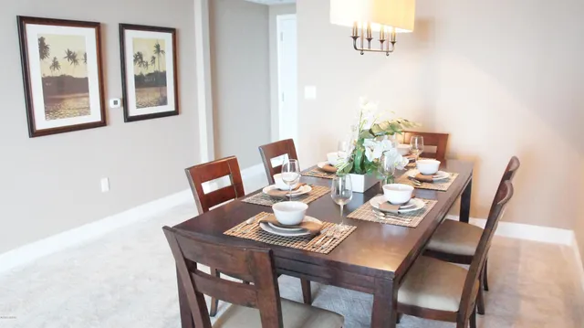 a kitchen with kitchen island a counter top space a sink stainless steel appliances and cabinets
