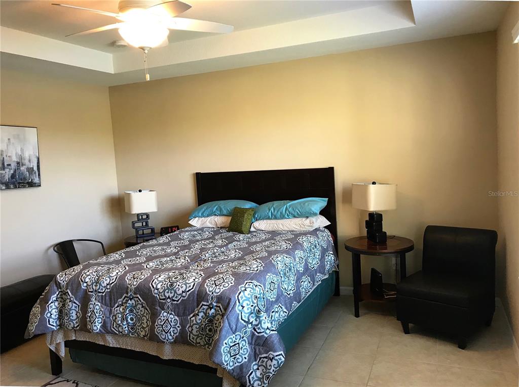 4169 Overture Circle, Unit 389 Bradenton, FL 34209 - Photo 11 of 25 a bedroom with a bed and a chandelier