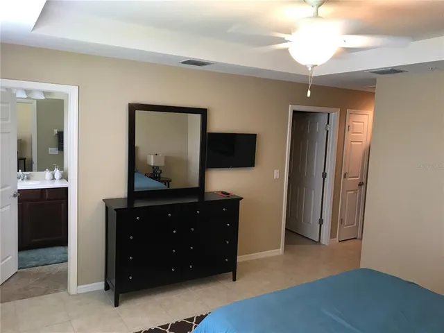 a living room with a dresser and a flat screen tv
