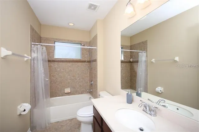 a bathroom with a sink toilet tub and shower