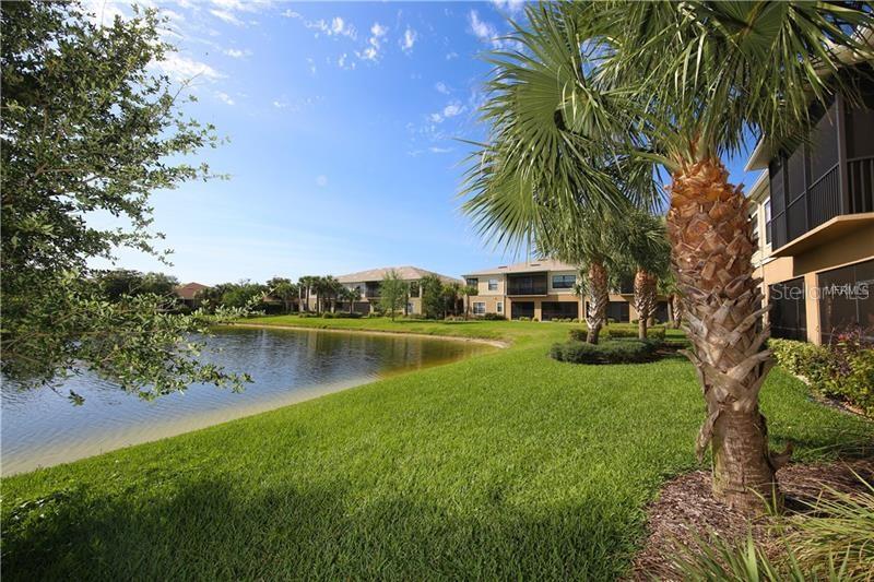 4169 Overture Circle, Unit 389 Bradenton, FL 34209 - Photo 18 of 25 a view of a lake with a house in the background