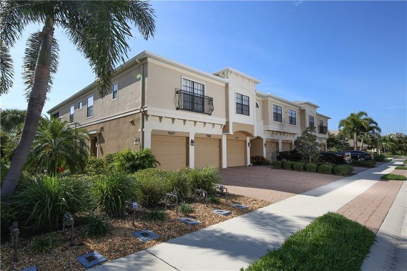 4169 Overture Circle, Unit 389 Bradenton, FL 34209 - Photo 2 of 25 a front view of a house with a garden