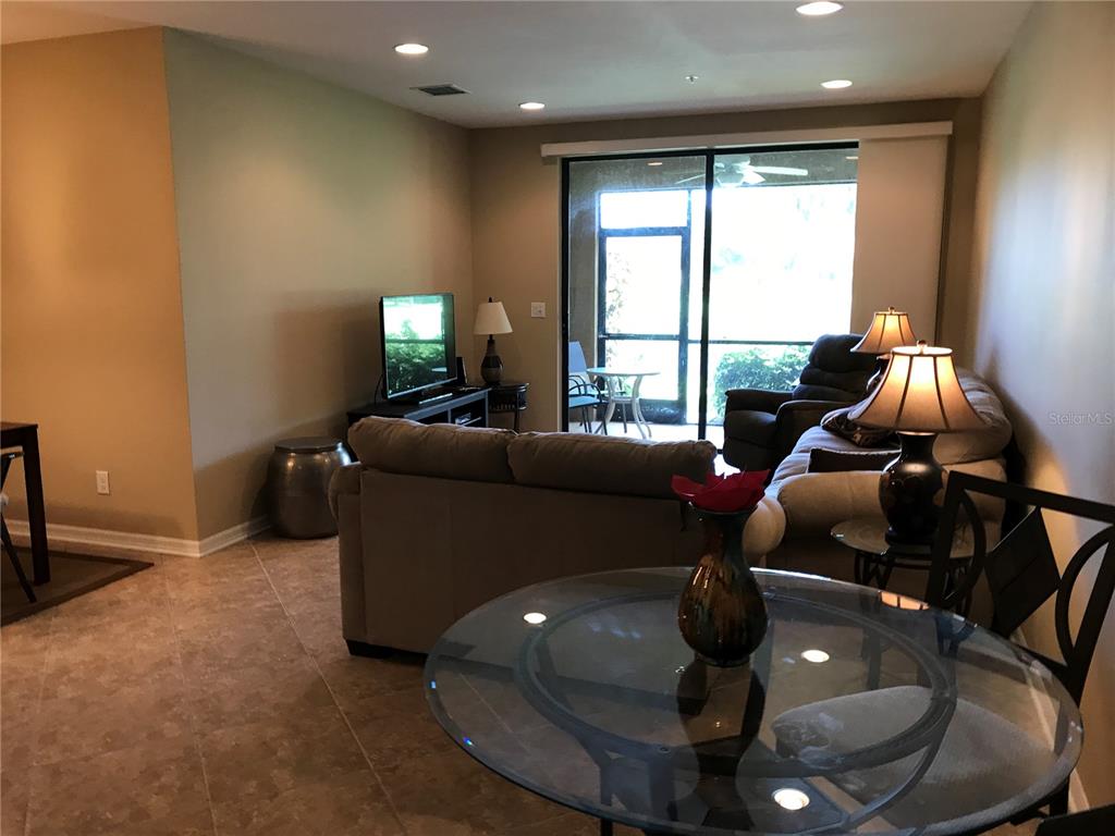 4169 Overture Circle, Unit 389 Bradenton, FL 34209 - Photo 6 of 25 a living room with furniture and a floor to ceiling window