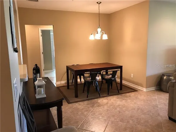a view of a dining room with furniture and chandelier