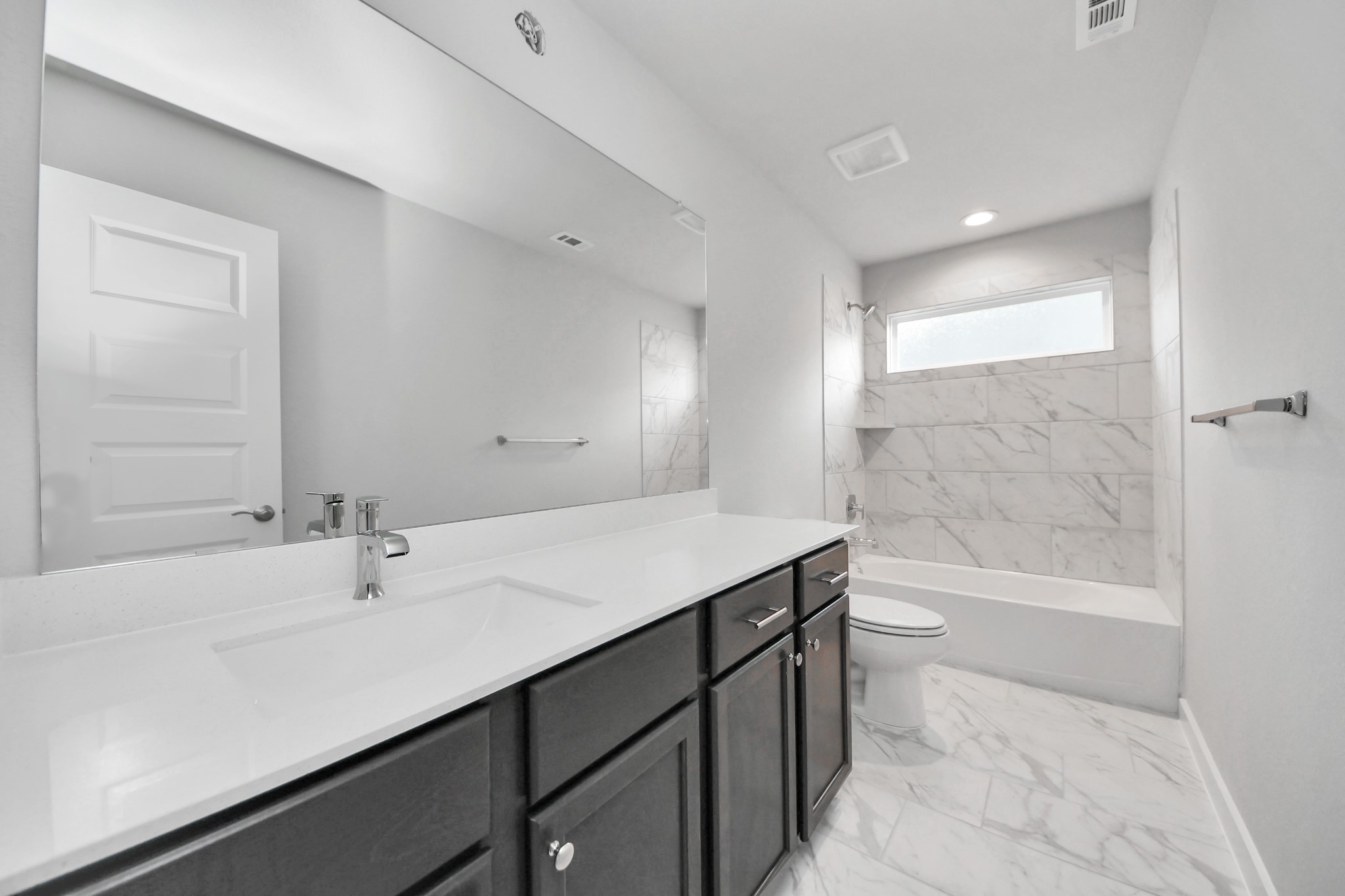 3110 Native Spg Drive Spring, TX 77373 - Photo 27 of 34 Secondary bath features tile flooring, bath/shower combo with tile surround, light stained wood cabinets, beautiful light countertop. Sample photo of completed home with similar floor plan. Actual colors and selections may vary.