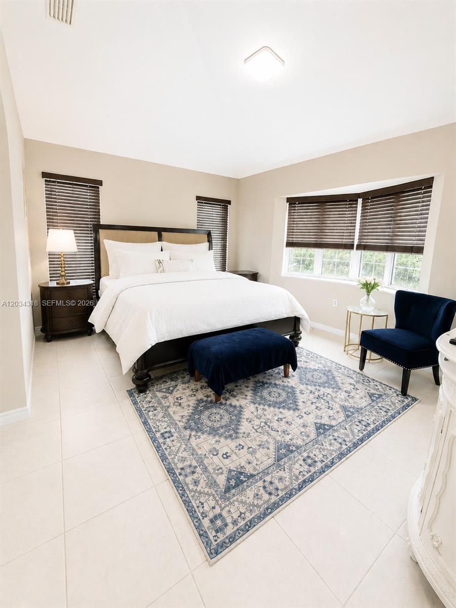 14856 Southwest 179th Street Miami, FL 33187 - Photo 16 of 33 a bedroom with a bed window and a couch