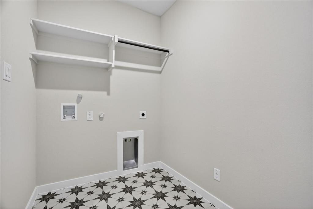 317 Skeen Peak Springtown, TX 76082 - Photo 25 of 31 Laundry room featuring star-patterned floor tiles and light neutral walls