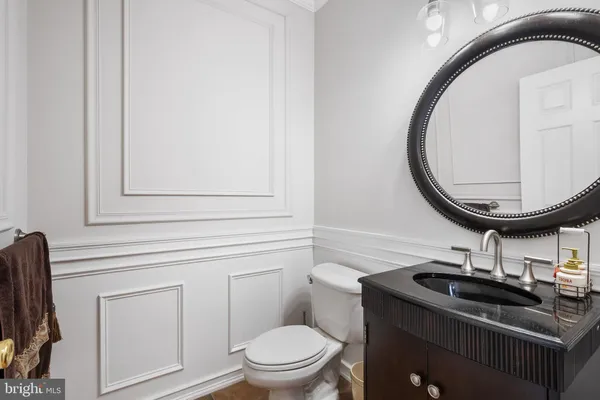 a bathroom with a sink a mirror and a toilet