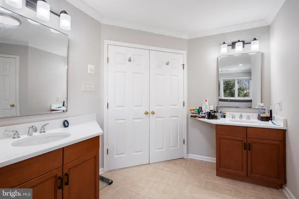 a bathroom with a sink vanity and mirror